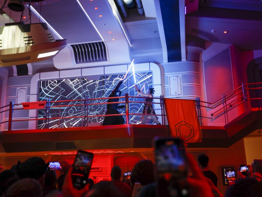Orlando, Fla - March 01: Kylo Ren, the Supreme Leader of the First Order, has a light saber battle with Rey, a force-wielding hero of the Resistance, as the first passengers experience the two-day Walt Disney World  Star Wars Galactic Starcruiser, which is a live action role playing game that doubles as a high-end hotel in Orlando, Fla. The event is billed as Halcyons 275th anniversary voyage across the galaxy. at Walt Disney World  Star Wars Galactic Starcruiser in Orlando, Fla on Tuesday, March 1, 2022. First Order lieutenant Harman Croy and his garrison of stormtroopers patrol the ship. Guests arrive at Batuu, a destination for a planet excursion. Players use a data pad to play the immersive game while they participate in activities such as light saber training. (Allen J. Schaben / Los Angeles Times via Getty Images)