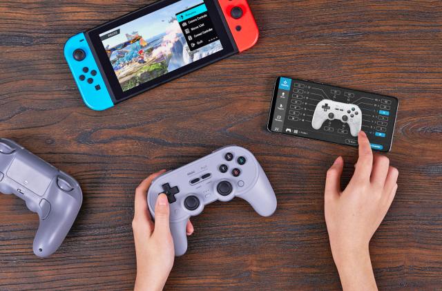 The 8BitDo wireless controller flanked by a Switch, a smartphone with controller setup graphics and two hands working the device.