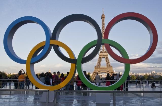 FILE - The Olympic rings are set up at Trocadero plaza that overlooks the Eiffel Tower, a day after the official announcement that the 2024 Summer Olympic Games will be in the French capital, in Paris, Thursday, Sept. 14, 2017. Swimming, gymnastics and track & field fans can rejoice. For the first time in a European Olympics, those events finals will be televised live on network television in the United States. (AP Photo//Michel Euler, File)