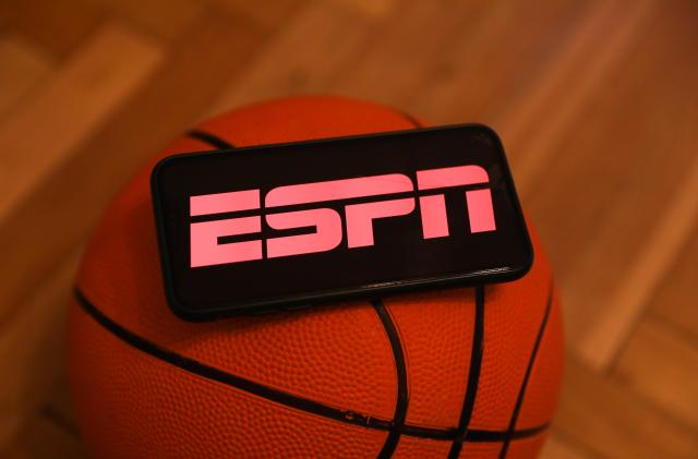 ESPN logo displayed on a phone screen and a basketball are seen in this illustration photo taken in Krakow, Poland on December 1, 2022. (Photo by Jakub Porzycki/NurPhoto via Getty Images)