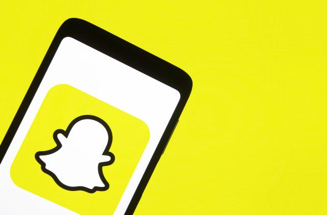 This illustration picture taken on 15 January 2021 shows the Snapchat logo displayed on a smartphone screen (Photo illustration by STR/NurPhoto via Getty Images)