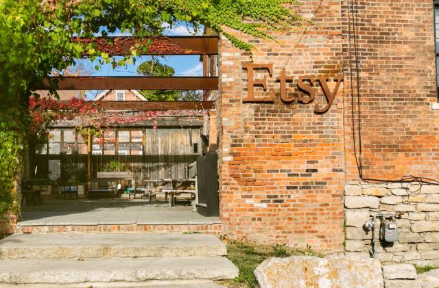 Entrance to Etsy offices with brick wall and stone stairs. 