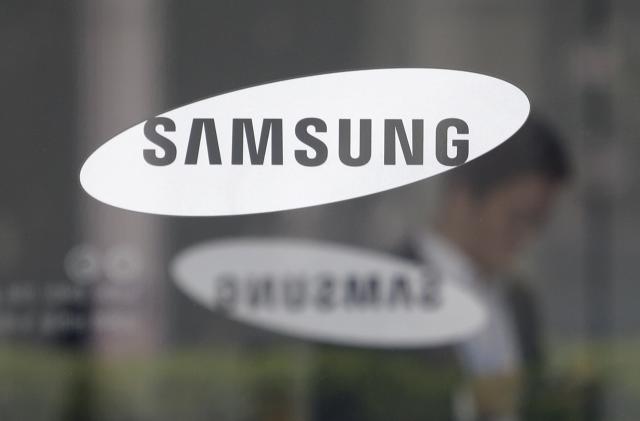 FILE - The logo of the Samsung Electronics Co. is seen at its office in Seoul, South Korea on April 30, 2019. Samsung Electronics said Wednesday, March 15, 2023, it expects to invest 300 trillion won ($230 billion) over the next 20 years as part of an ambitious South Korean national project to build the world’s largest semiconductor manufacturing base near the capital, Seoul. (AP Photo/Ahn Young-joon, File)