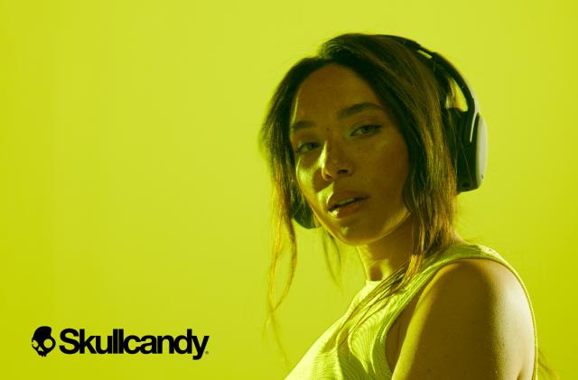 Skullcandy unveils the Crusher 2 ANC headphones with an image of a lady over a yellow background wearing the headphones. 