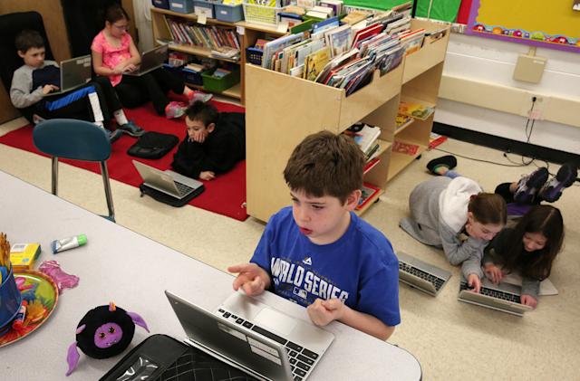 Seth Erdman, center, and his fellow students use Chromebooks while working on a lesson in a third grade class on Friday, Jan. 16, 2015, at Walden Elementary School in Deerfield, Ill. (Anthony Souffle/Chicago Tribune/TNS via Getty Images)