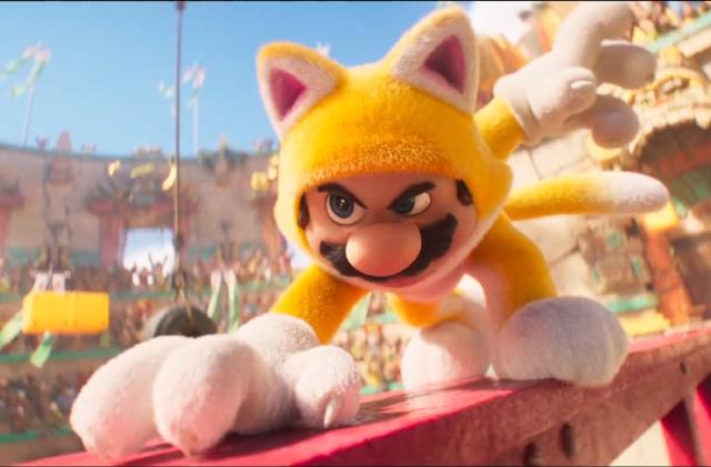 A screengrab from The Super Mario Bros. Movie showing Mario's cat costume. Mario prepares to lunge at Donkey Kong. 