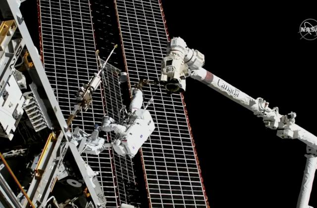 Astronauts conduct a spacewalk to replace a faulty antenna on the International Space Station (ISS) in a still image from video December 2, 2021.  NASA TV/Handout via REUTERS THIS IMAGE HAS BEEN SUPPLIED BY A THIRD PARTY.