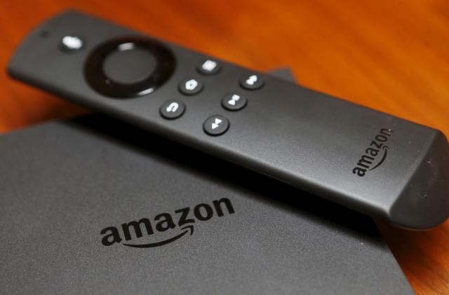 The new Amazon Fire TV is displayed during a media event introducing new Amazon products in San Francisco, California September 16, 2015. Amazon on Thursday rolled out a line of tablets and revamped Fire TV gadgets. The $99.99 Fire TV set-top box integrates its cloud-based virtual assistant Alexa, allowing viewers to check the weather, look up sports scores and play music. Photo taken September 16, 2015.  REUTERS/Beck Diefenbach