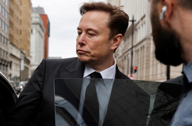 Tesla CEO Elon Musk and his security detail depart the company’s local office in Washington, U.S. January 27, 2023.  REUTERS/Jonathan Ernst