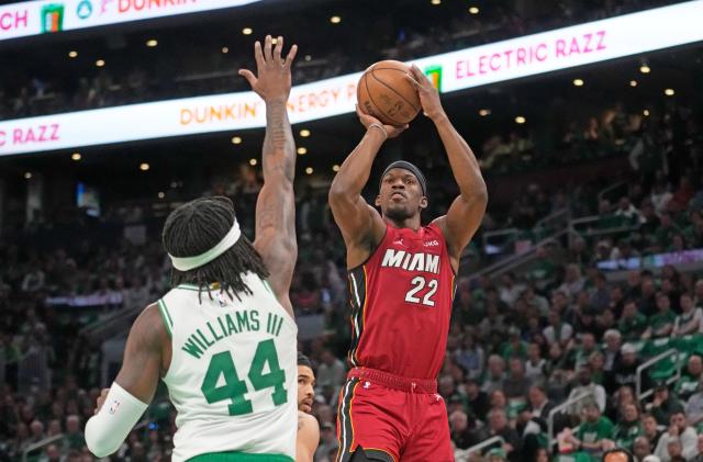 Miami Heat forward Jimmy Butler (22) shoots against Boston Celtics center Robert Williams III (44) in the first half of game 1 of the NBA basketball Eastern Conference finals playoff series in Boston, Wednesday, May 17, 2023. 