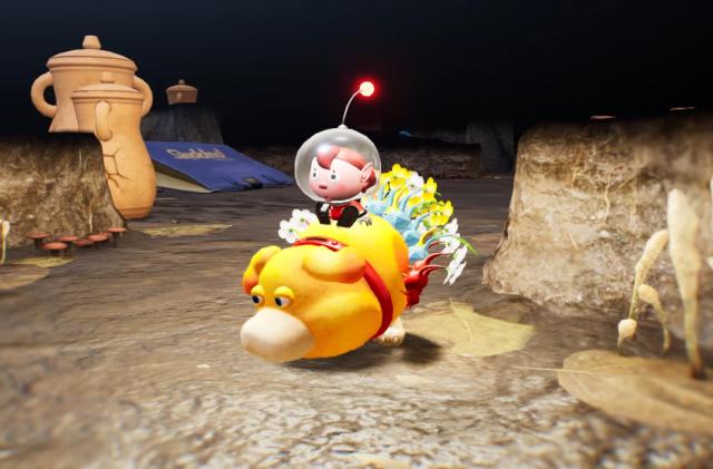 A group of plant-like Pikmin and a castaway astronaut ride on the back of a round, yellow dog in the Switch game, Pikmin 4.