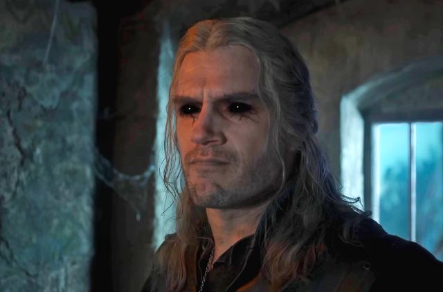 A close up of Henry Cavill as Geralt in 'The Witcher' season 3, showing him with dark black eyes and dark veins surrounding them.