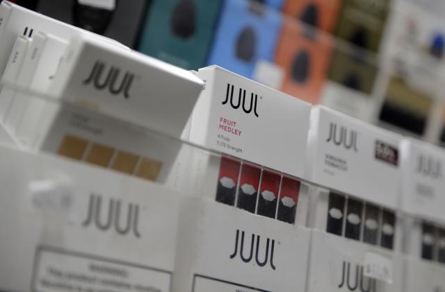 FILE - In this Dec. 20, 2018, file photo Juul products are displayed at a smoke shop in New York. Shares of Altria Group, the nation’s largest tobacco company, fell Thursday, April 25, 2019. Quarterly results were weighed down by $159 million in expenses mainly tied to Altria’s investments in Canadian cannabis investment firm Cronos and Juul, the e-cigarette startup company. (AP Photo/Seth Wenig, File)