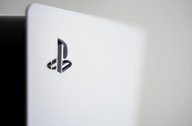 The PlayStation 5 logo on the surface of a PS5 console. (Photo by Nikos Pekiaridis/NurPhoto via Getty Images)