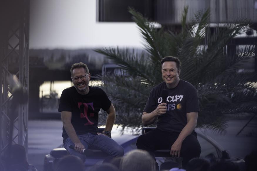 BOCA CHICA BEACH, TX - AUGUST 25: SpaceX founder Elon Musk and T-Mobile CEO Mike Sievert on stage during a T-Mobile and SpaceX joint event on August 25, 2022 in Boca Chica Beach, Texas. The two companies announced plans to work together to provide T-Mobile cellular service using Starlink satellites. (Photo by Michael Gonzalez/Getty Images)