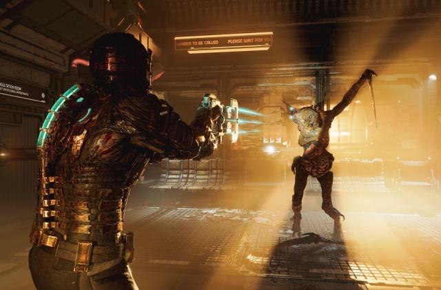 Isaac Clarke, the protagonist of Dead Space, aims his weapon at a necromorph that is standing, menacingly silhouetted against a harsh light on a space ship.