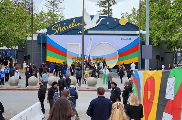 A scene from outside of the shoreline theater where Google I/O is being held. People are seen strolling along the walkways.