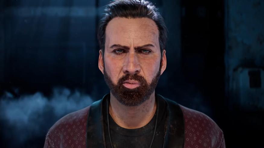 Shadowy closeup of Nicolas Cage from the shoulders up in ‘Dead by Daylight.’ He is staring at the camera with an intense and perhaps unsettling glare. Darkness and hints of smoke hover in the background.